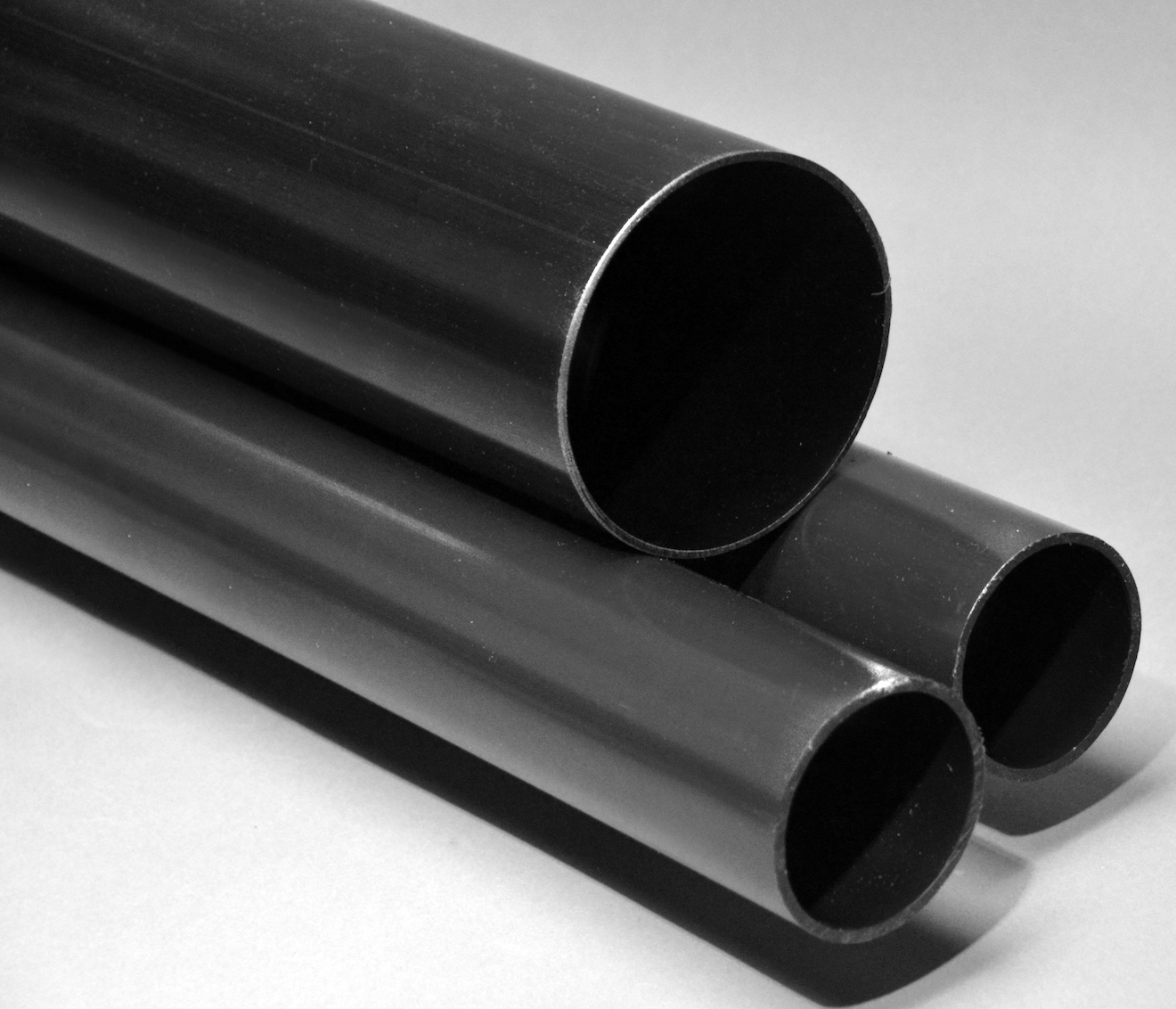 Black plastic tubing and extruded material samples