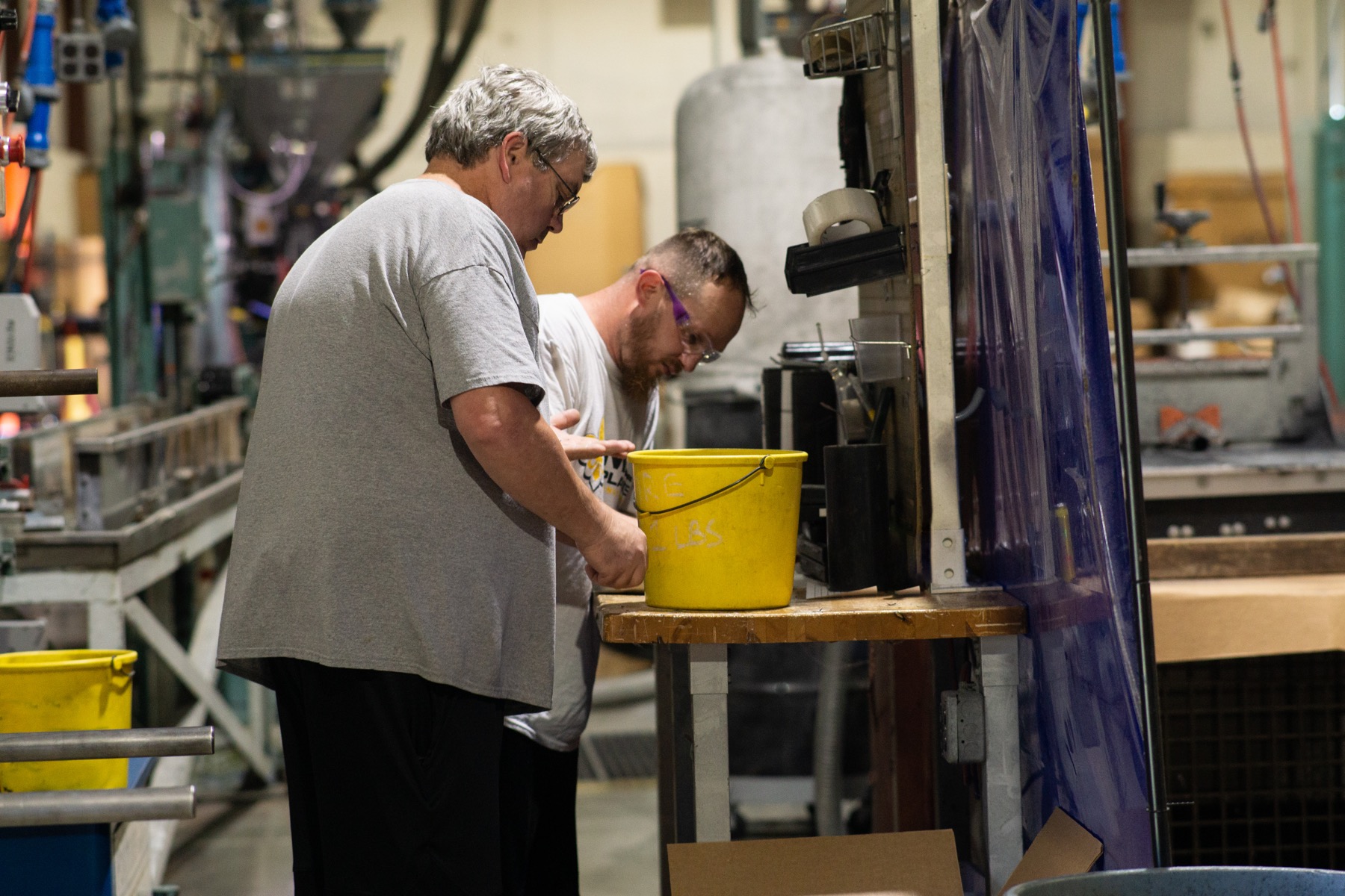 Two Hamilton facility team members checking work on the production line